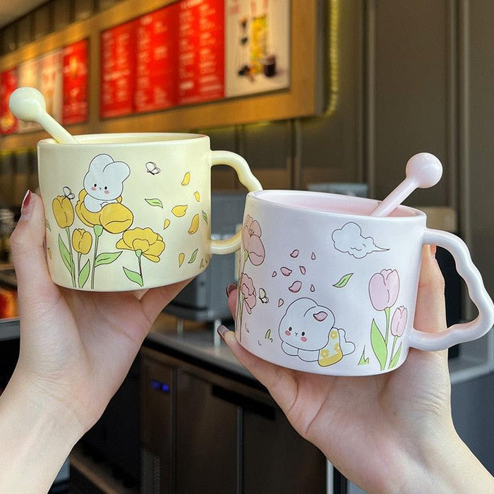 Pair of white bunny flower mugs with tulip illustrations and spoon-shaped handles
