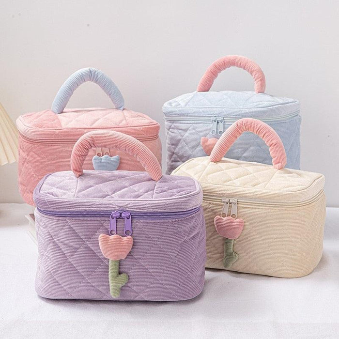 Quilted fabric makeup bag set with pastel pink, purple, and light blue zip tops