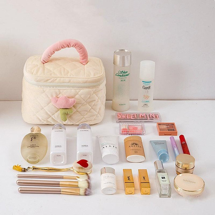 Quilted cream makeup bag with handle and heart flower charm, zip top