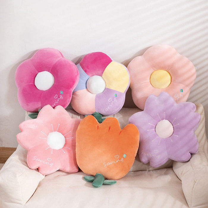 Assorted pastel flower plush toys with white centers and stitched petal details