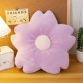 Lilac flower plush pillow with round white center and radiating stitched petal tips