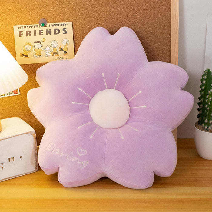 Lilac flower plush pillow with round white center and radiating stitched petal tips