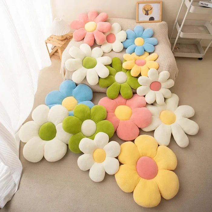 Set of flower-shaped plush pillows with white, green, blue, yellow, and pink petals