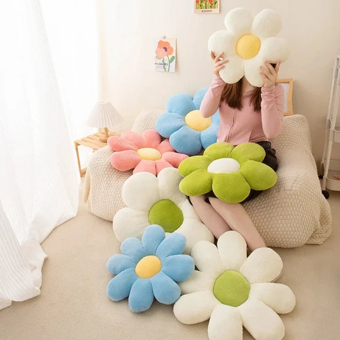 Large flower-shaped plush pillow with white and green petals and soft pastel colors
