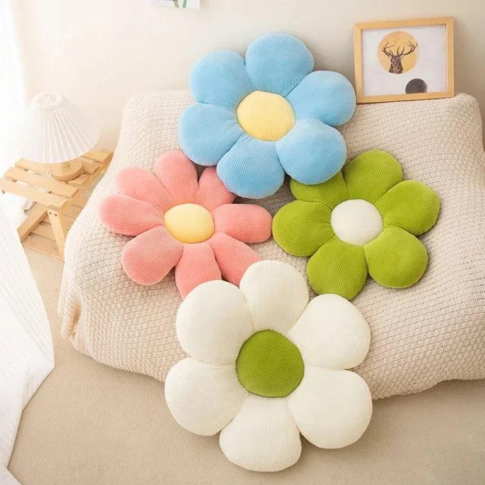 Flower-shaped plush pillow cluster with light blue, pink, green, and white petals