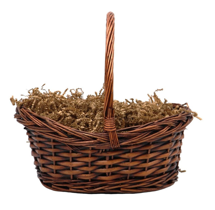 Wicker gift basket filled with shredded filler and tied handle