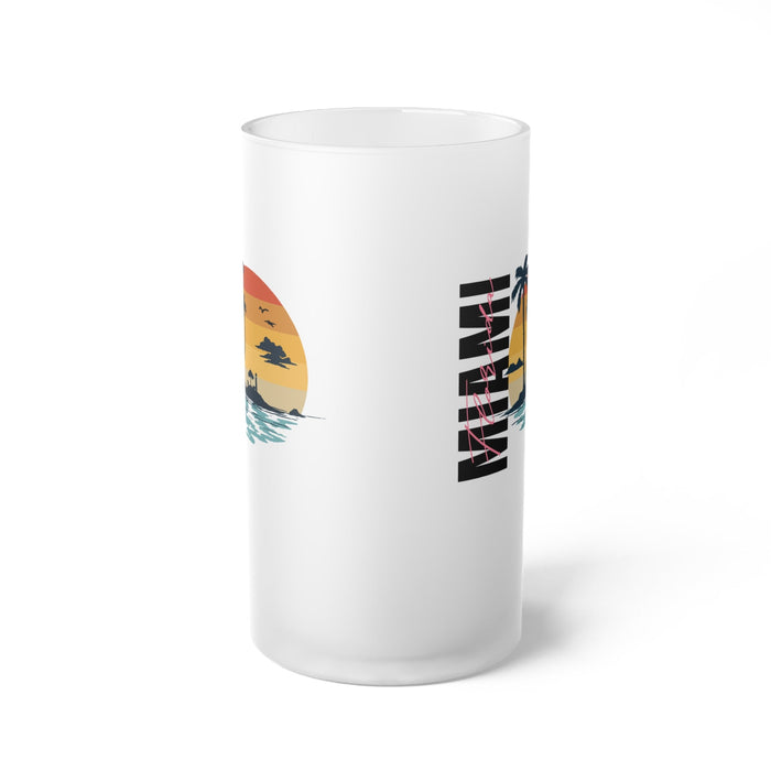 Frosted glass beer mug showing partial palm sunset graphic on side