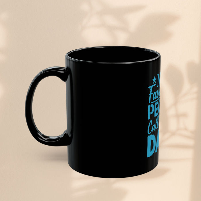Black mug angled view showing blue print edge and handle