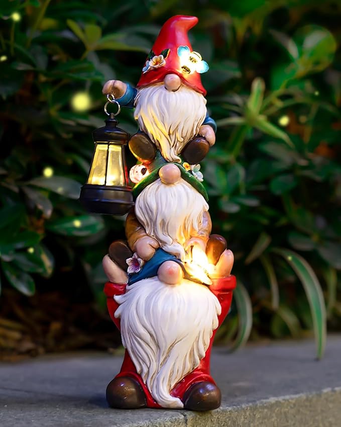 Triple garden gnome statue with red hats, holding a lantern with glowing solar light