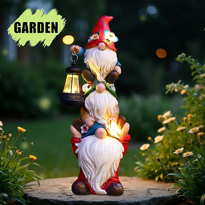 Triple gnome solar lantern statue in garden at night with glowing lantern and beards