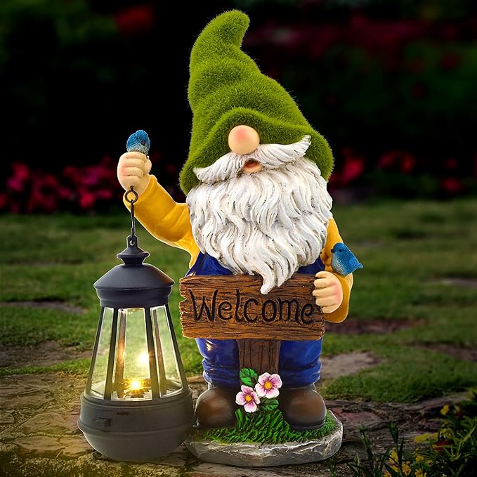 Green-hat garden gnome statue holding a solar lantern with warm light and a “Welcome” sign