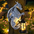 Silver dragon tree-hugger statue with solar lantern and gold chest detail