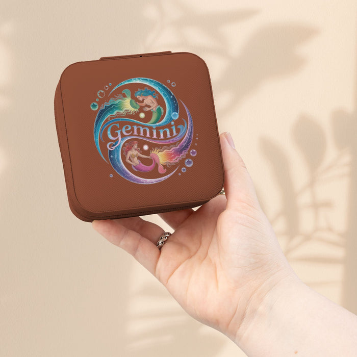 Brown zippered jewelry travel case with Gemini zodiac graphic on front.
