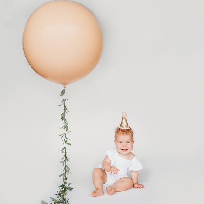 Peach giant balloon with hanging ribbon and tassel cluster