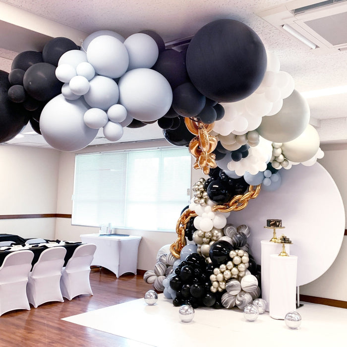 Black and white giant balloon garland with gold chain centerpiece