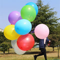 Assorted large latex balloons in blue, green, pink, red, yellow, and purple.