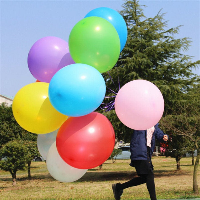 Assorted large latex balloons in blue, green, pink, red, yellow, and purple.