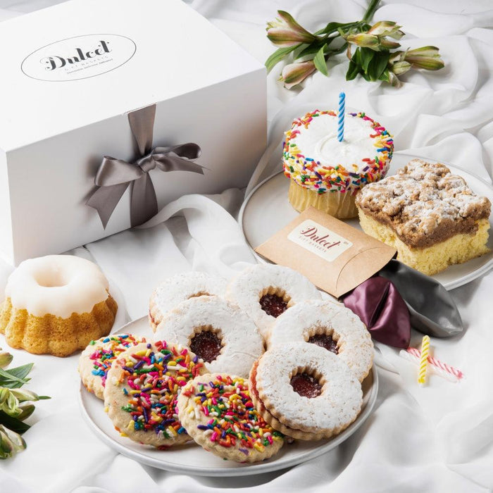 Birthday sweets gift box with assorted cookies and cupcake, tied with ribbon bows