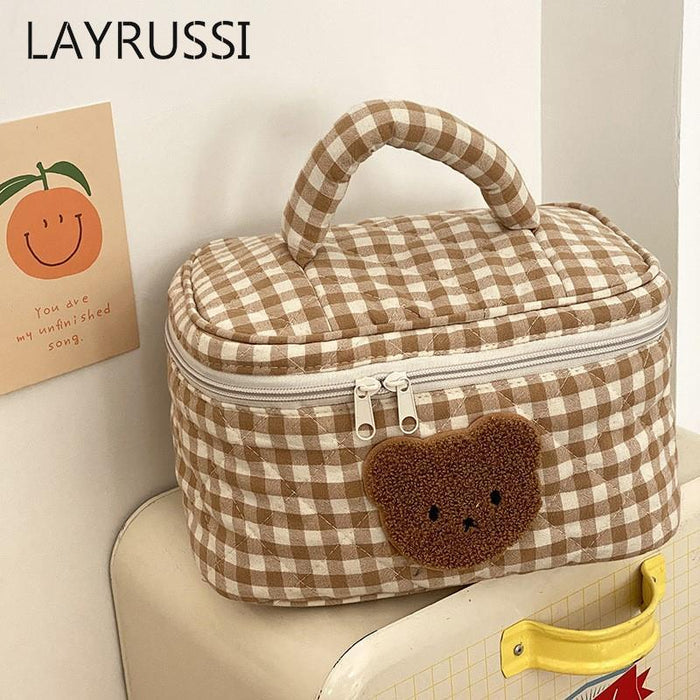 Gingham teddy bear cosmetics bag with top handle, zipper, and bear face applique