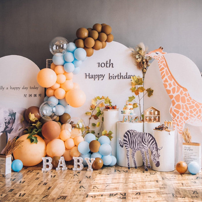 Giraffe safari balloon garland kit with blue, mocha, and orange balloons plus giraffe birthday decor