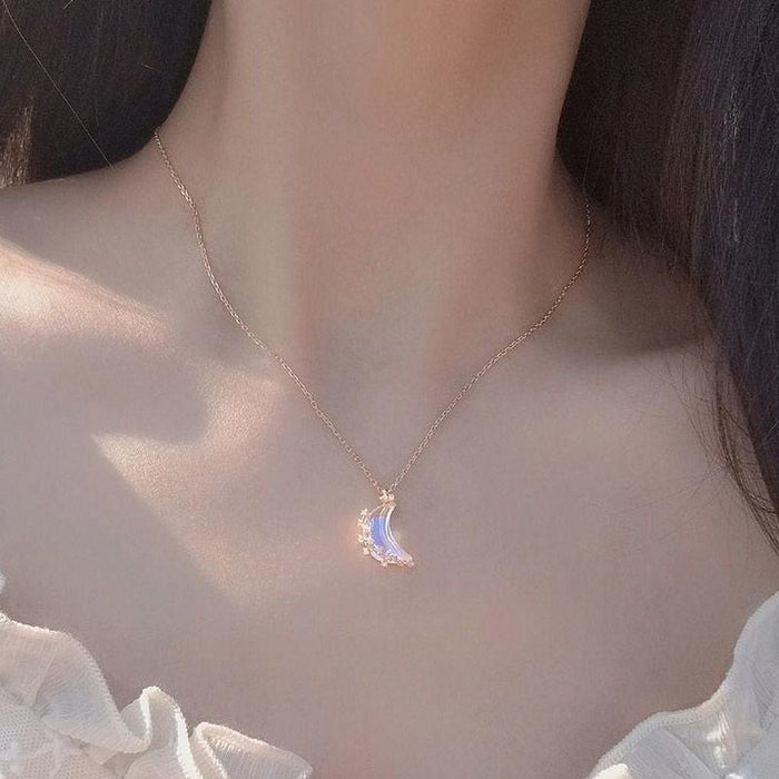 Silver moon pendant necklace with blue iridescent glazed crescent charm on thin chain