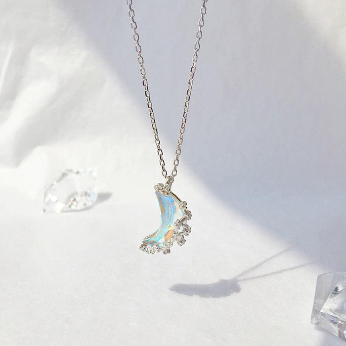 Silver moon pendant necklace with blue iridescent crescent charm and small star details