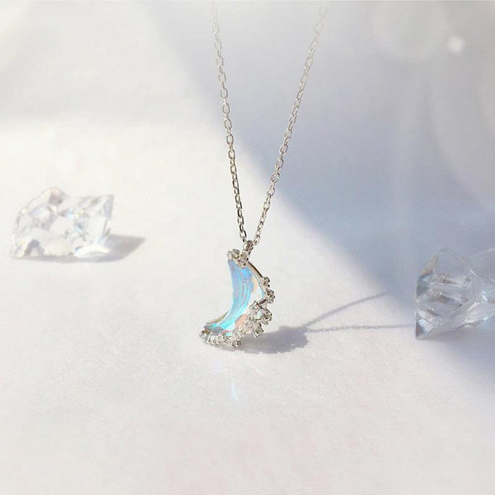 Silver moon pendant necklace with blue iridescent crescent charm and starry accents on chain