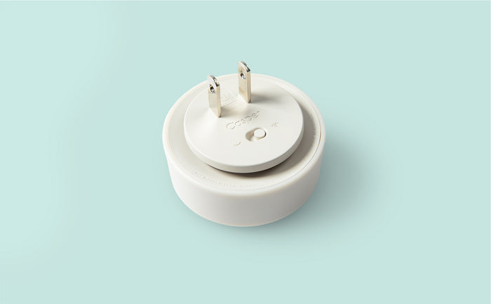 Close-up image of the back of a Glow Nightlight with two prongs that plug into the wall.