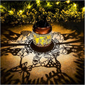 Copper solar lantern with cutout gnome design, warm LED glow on ground