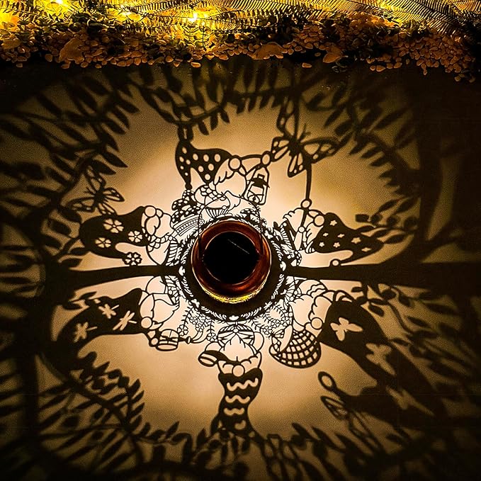 Solar lantern top view with glowing cutout gnome pattern inside metal jar