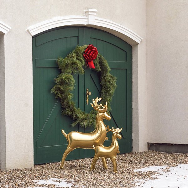 Gold deer foil balloon standing with garland wreath nearby