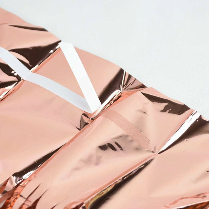 Rose gold metallic fringe curtain close-up with shiny ribbon-like strips