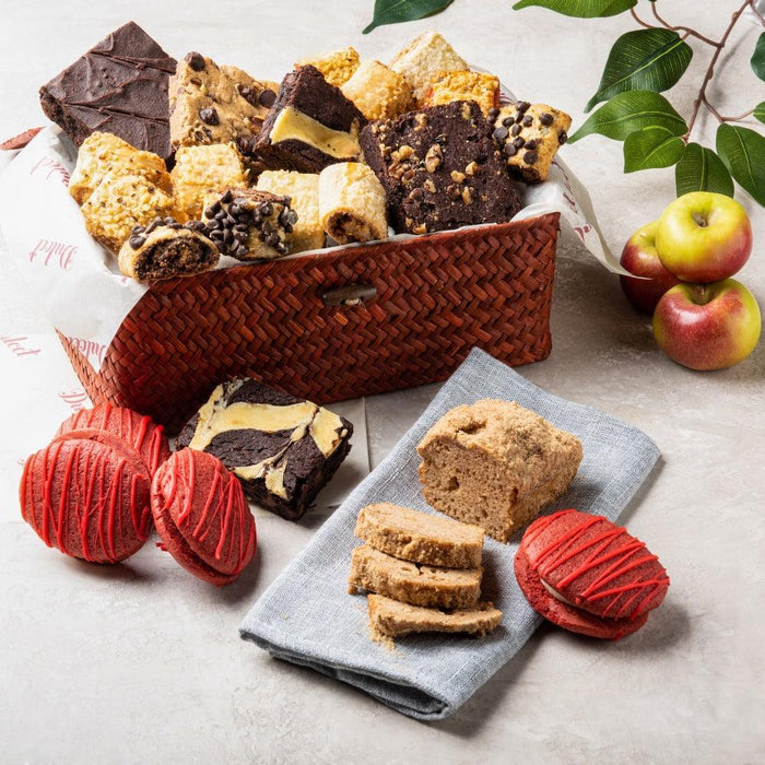 Wicker basket filled with assorted cookies and brownies, including apple-cinnamon pieces