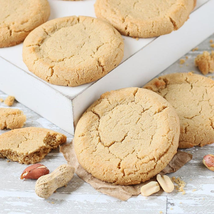 Cracked sugar cookies with nuts and crumbs on parchment, autumn cookie assortment