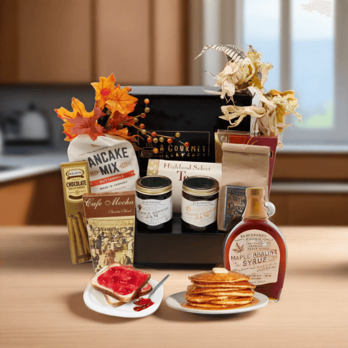 Open breakfast gift box with pancake mix, jam jars, syrup bottle, and mini pancakes