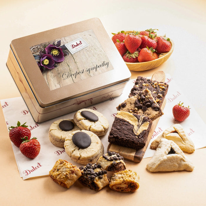 Cookie and brownie tin with assorted pastries on the lid and tray