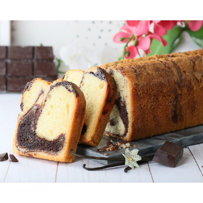 Sliced tea bread loaf with dark swirl center on a metal tray