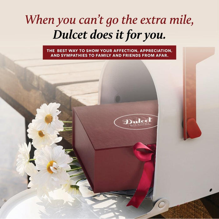 Gift basket with burgundy box, red ribbon, and greeting card with flower decor