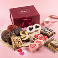 Valentine gift box with ribbon and assorted cookies and brownies on a serving tray