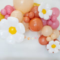 Balloon garland with white daisies and pink, peach, orange, and beige balloons
