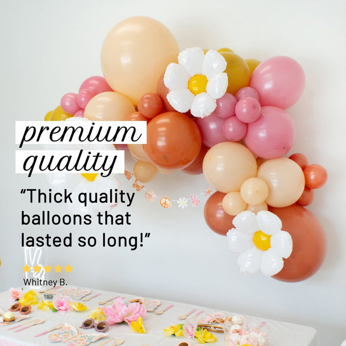 Balloon garland with white daisy balloons and pink, orange, and cream balloons