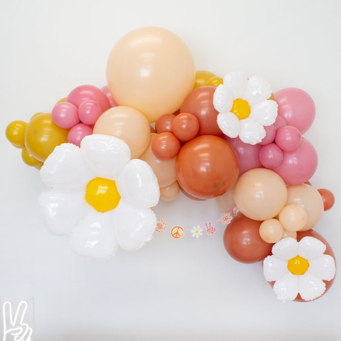 Pastel balloon arch with white daisy foil balloons and yellow centers