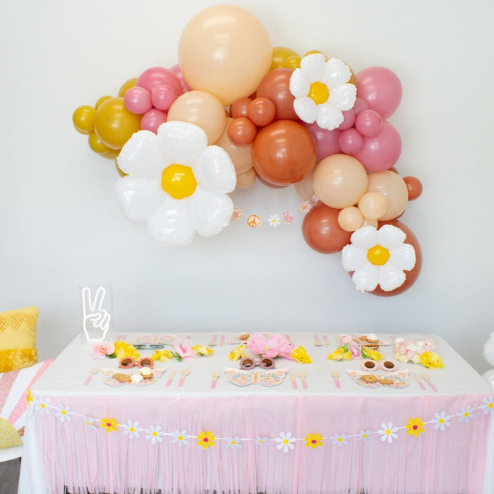 Pastel balloon arch featuring three white daisy foil balloons with yellow centers