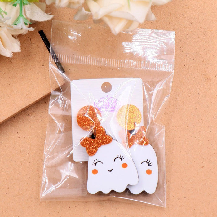 Orange glitter ghost face earrings in clear retail package with white display cards