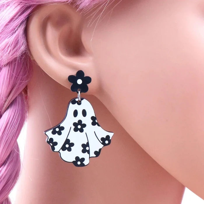 Ghost earrings on ear: black flower stud with white ghost charm and black floral dots