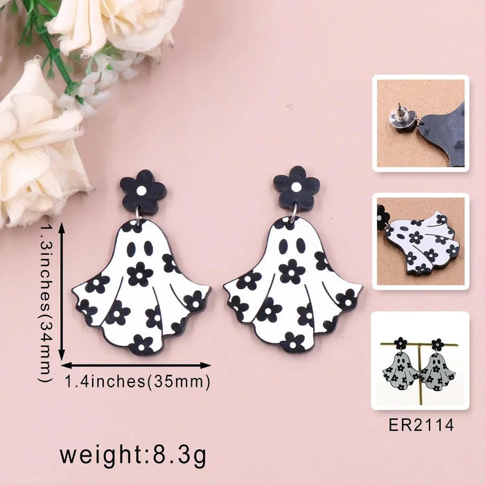 Ghost earrings with white ghost charms and black flower studs, front view