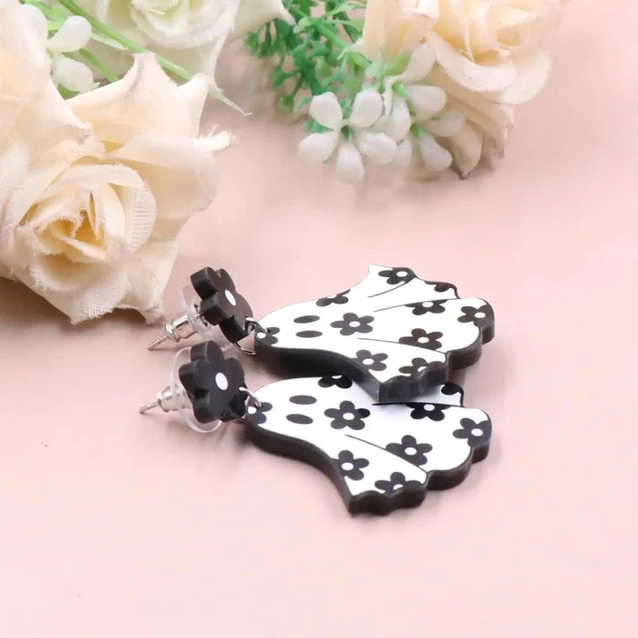 Ghost earrings pair with white ghost charms, black flower studs, and black floral dot pattern