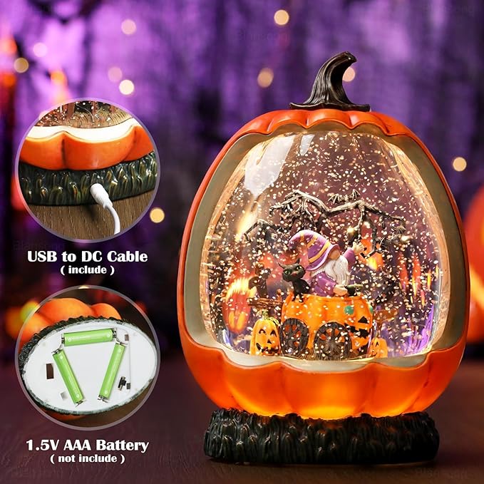 Orange pumpkin-shaped snow globe with swirling glitter and a textured black bottom stand