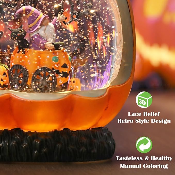 Orange pumpkin snow globe close-up with swirling glitter and textured black base