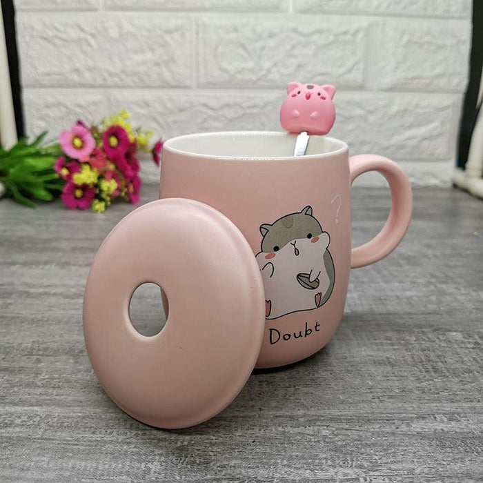 Pink hamster-themed ceramic mug with lid and donut-shaped coaster, side cat-hamster art